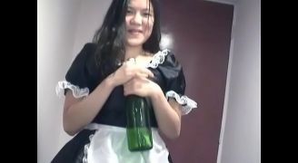 A Young Asian Girl Dressed As A Waitress Pampers Herself With A Bottle Of Champagne In Front Of The Camera For You